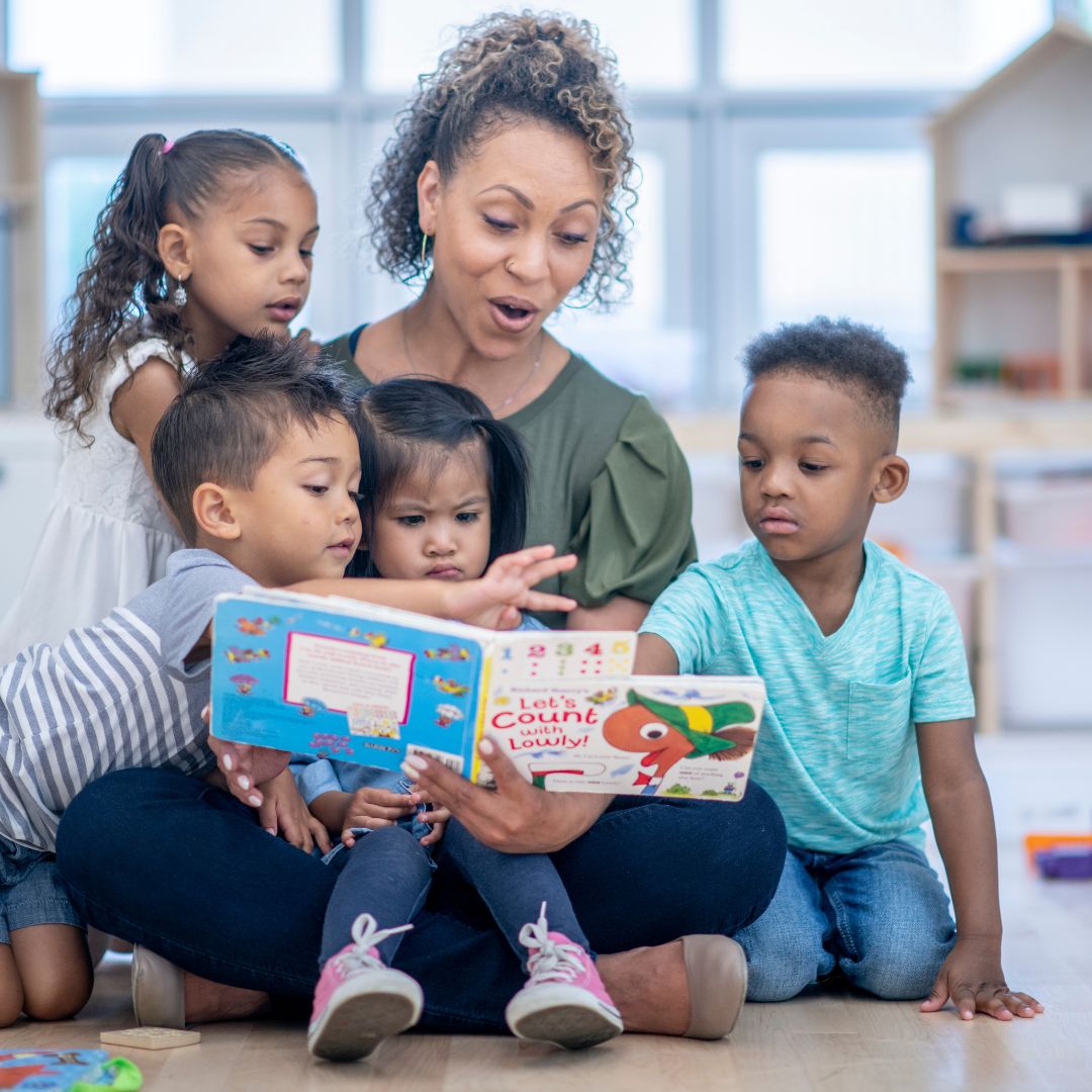 Daycare teacher reading with children
