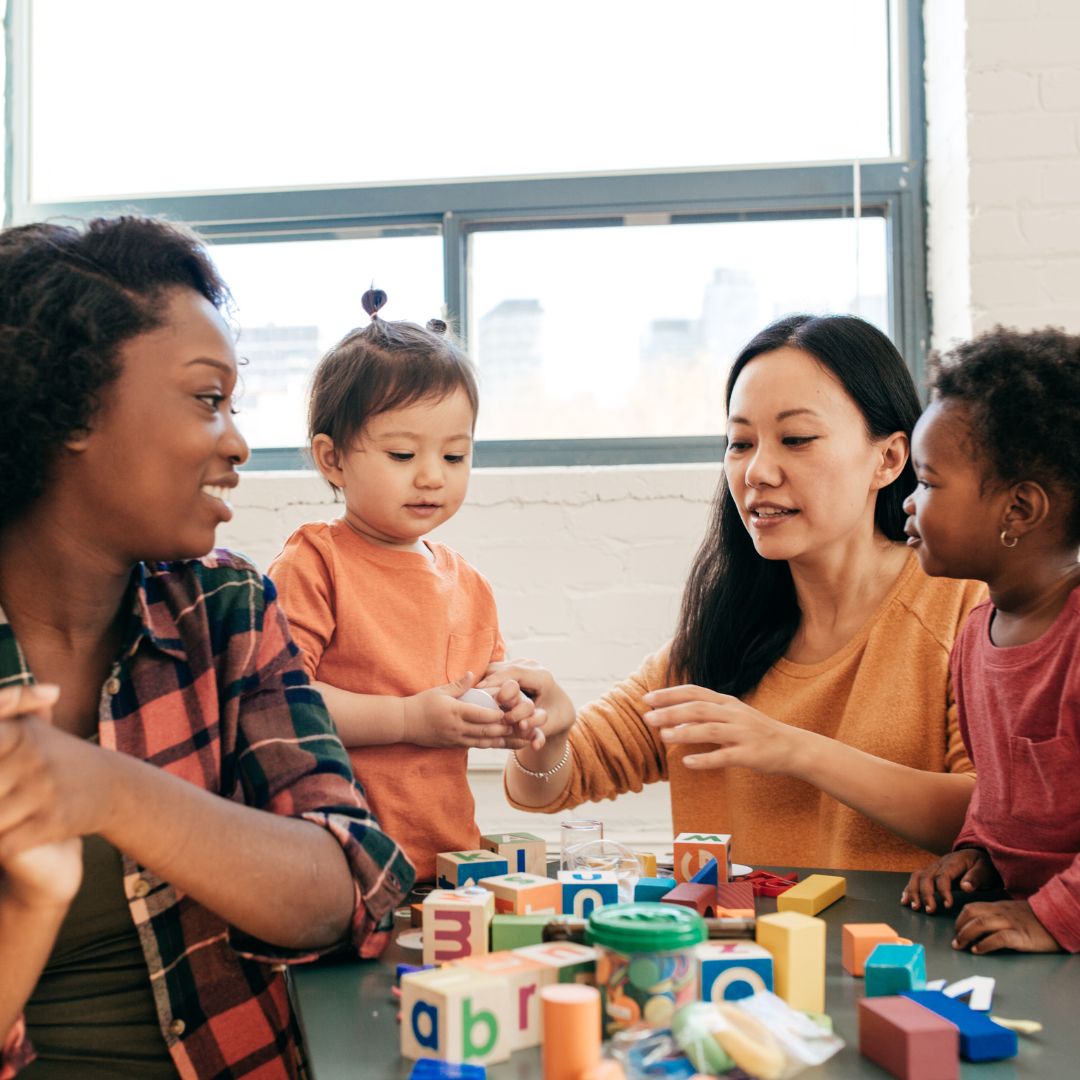 Daycare teachers playing with children