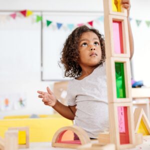 preschool girl playing with building blocks