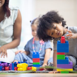preschool boy playing with building blocks